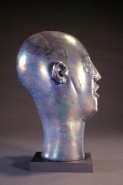 Head As Egg Chocolate Iridescent Lava Bust Side View by Richard Jolley